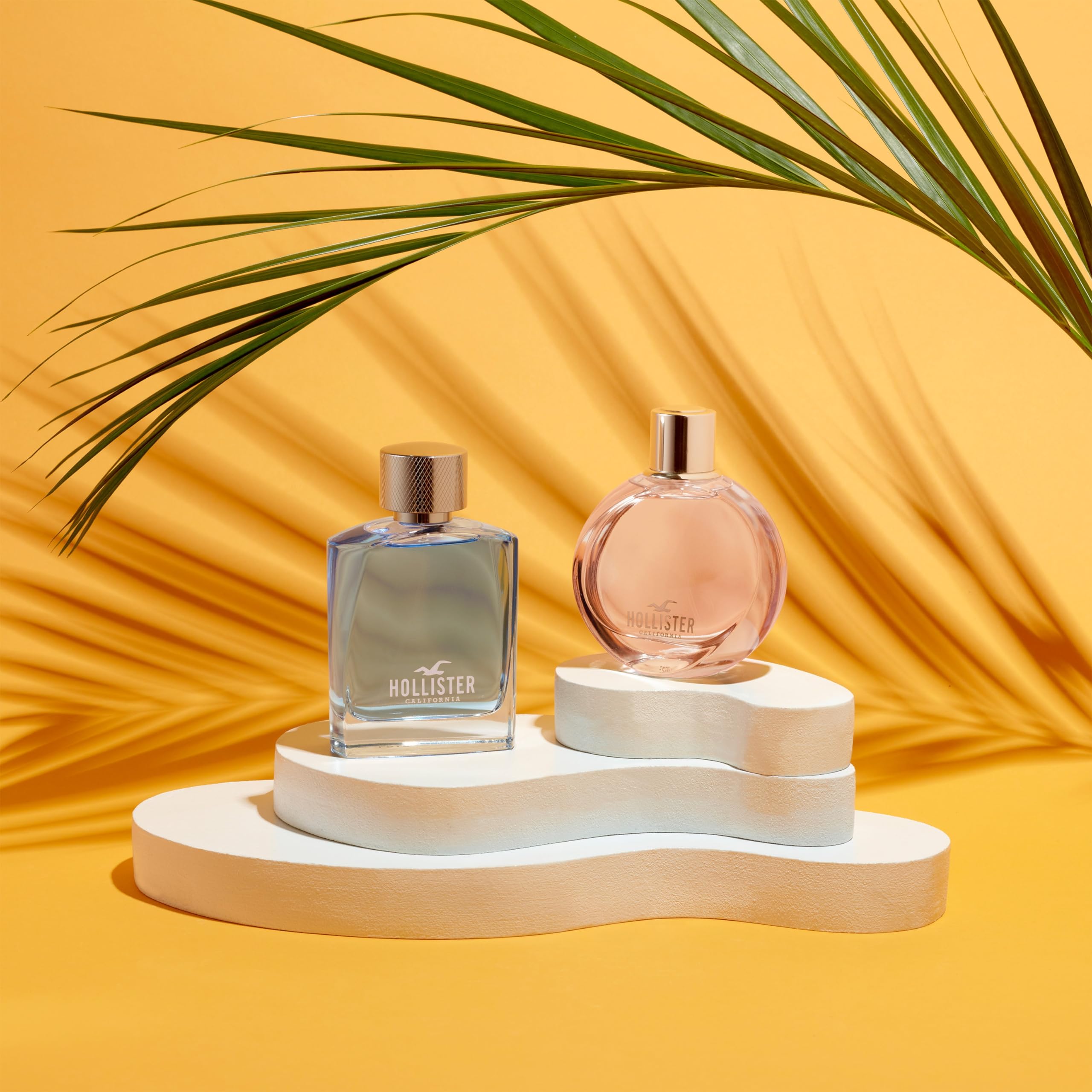 Side view of the wave shaped glass bottle of Hollister Wave for Her premium international fragrance.