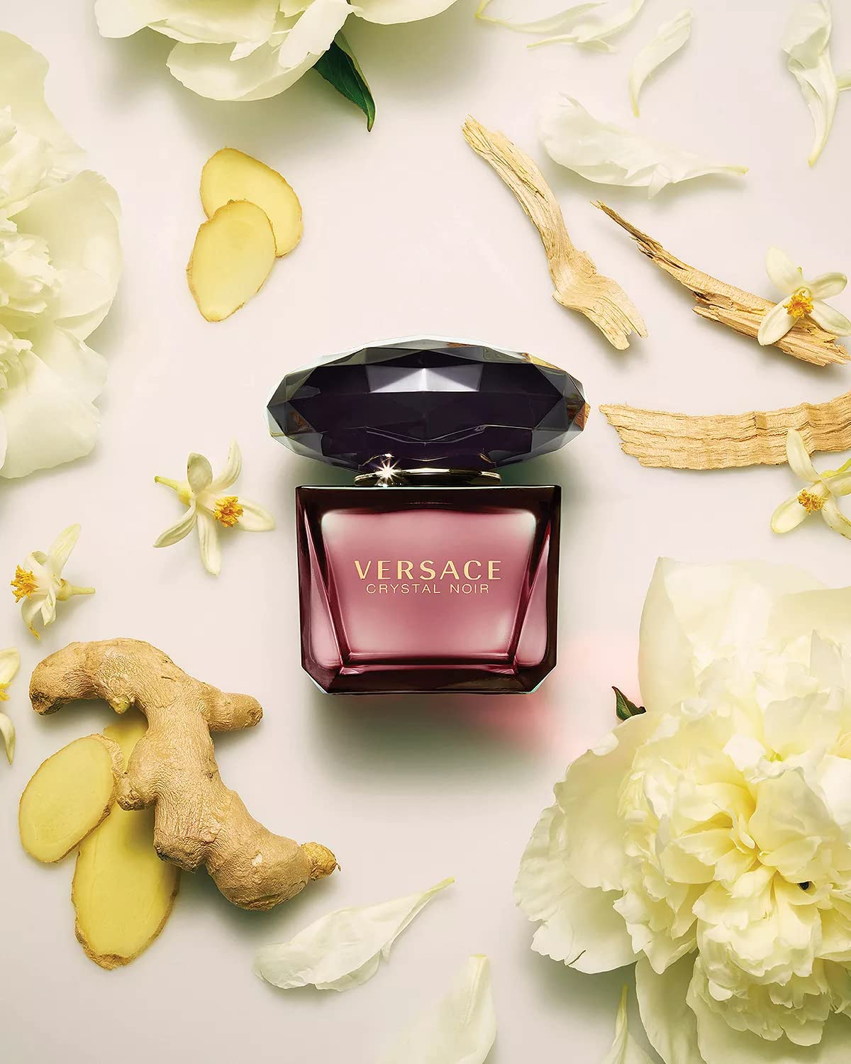 Close up of dark red Versace Crystal Noir fragrance bottle