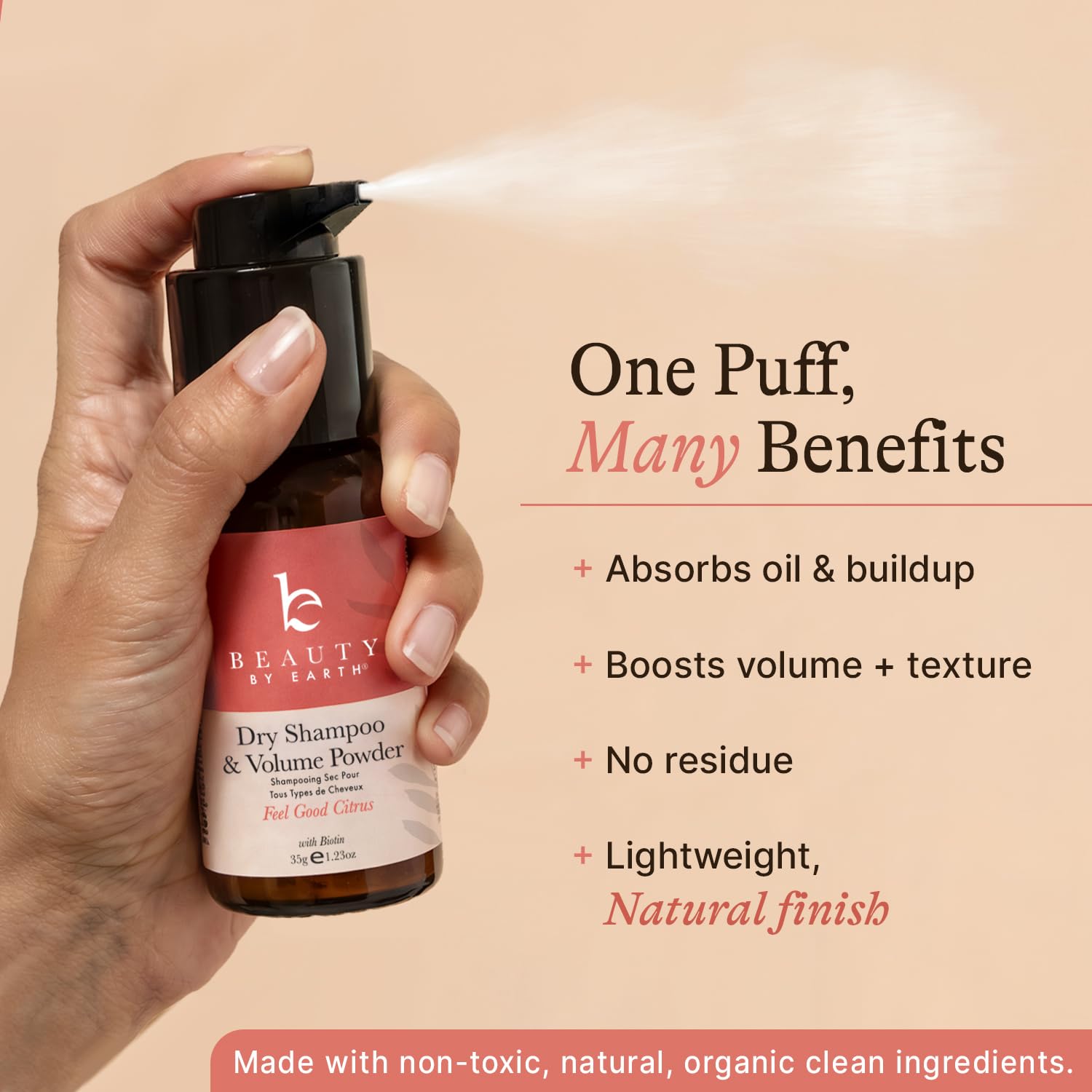 Hand holding Beauty by Earth natural dry shampoo bottle