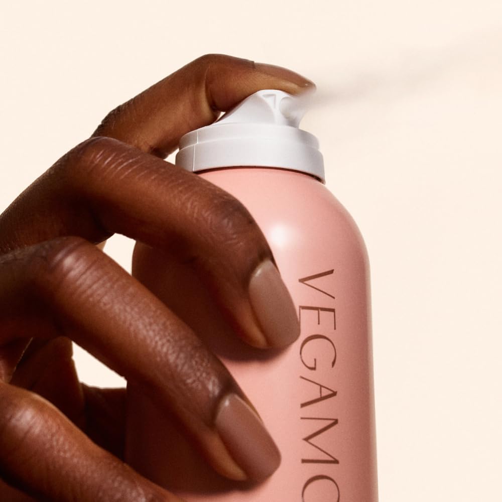 Vegamour volumizing hair spray being applied to roots for clean texture
