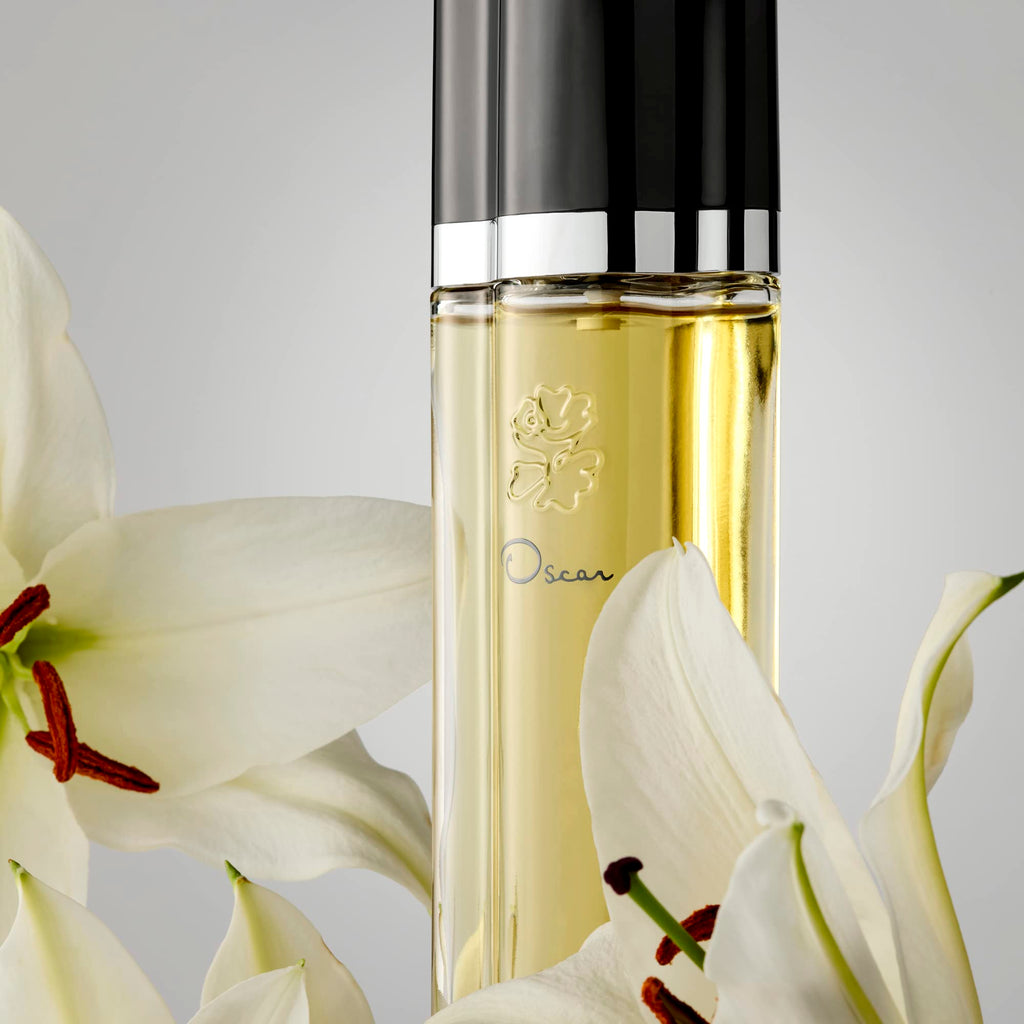 Oscar De La Renta perfume bottle held in hand