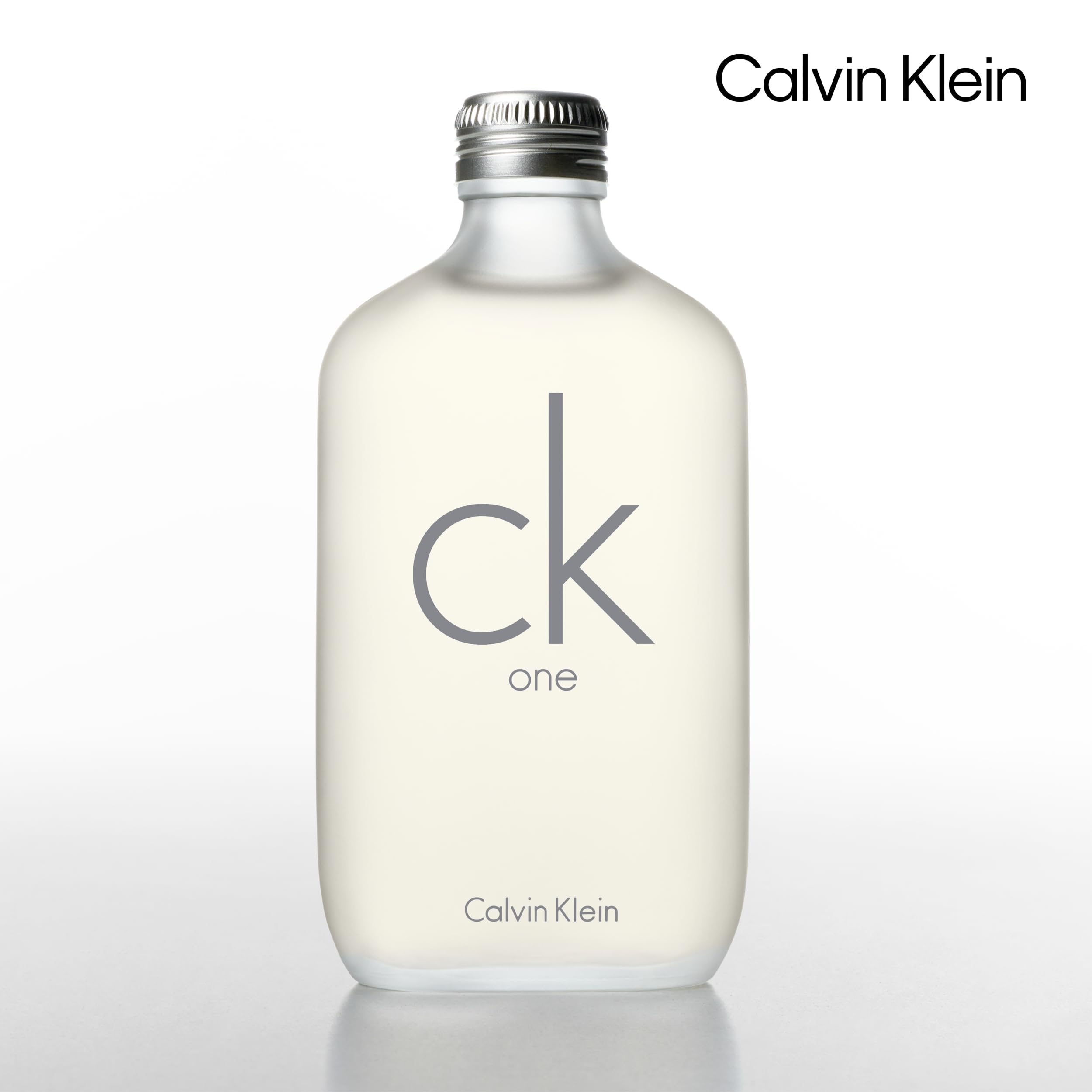 Calvin Klein CK One bottle with citrus and green tea leaves