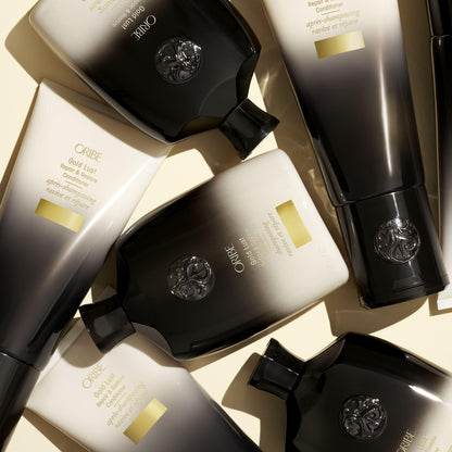 Side profile of the 250ml Oribe Gold Lust shampoo container showing authentic batch code information.