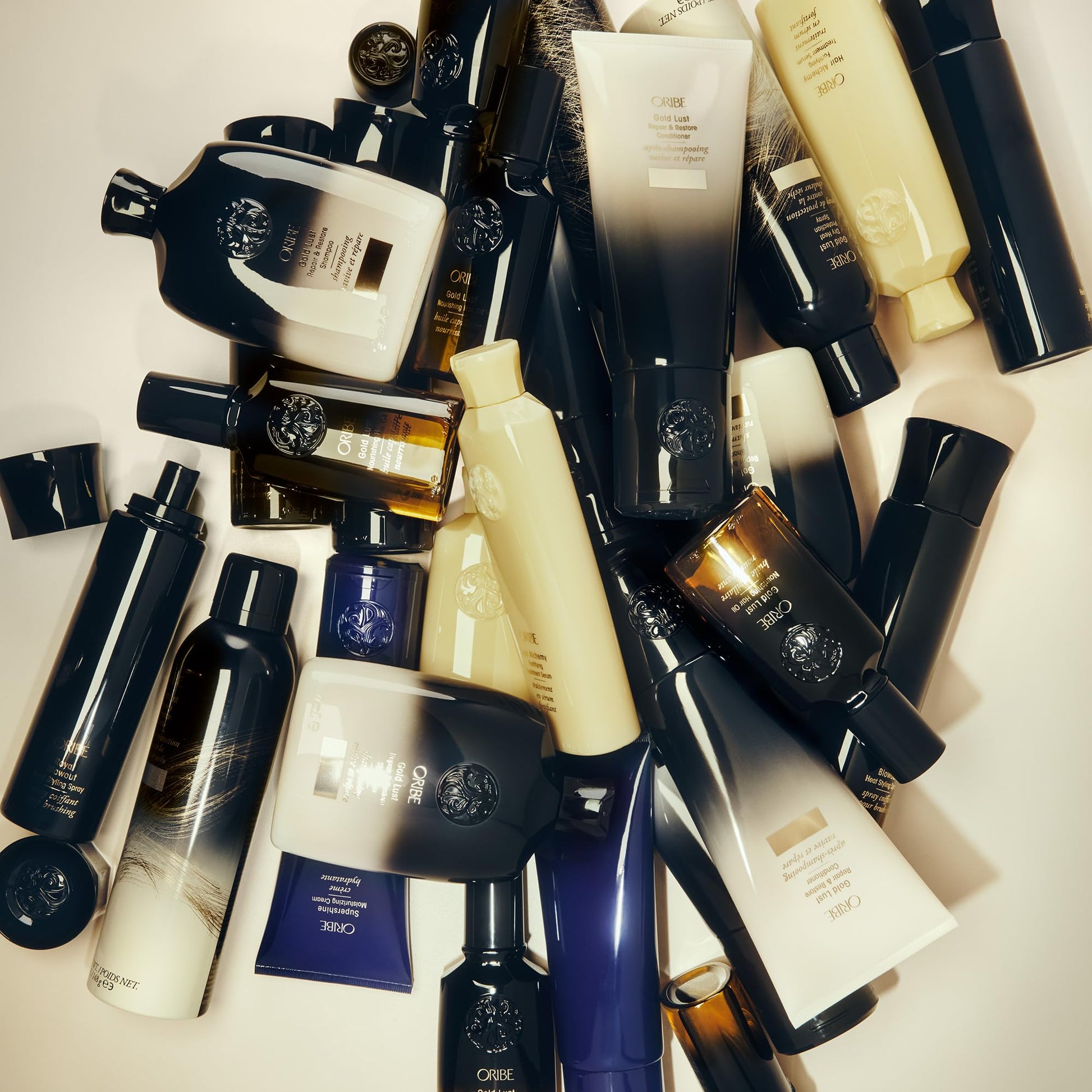 Full collection view of the authentic Oribe Gold Lust Repair and Restore hair cleanser bottle display.