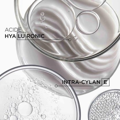 Close up of Kérastase Densifique premium hair thickening shampoo text packaging.