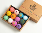 Open gift box displaying twelve handcrafted moisturizing bath pieces.