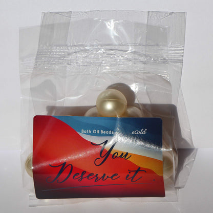 Ivory white retro bath pearls dissolving in warm running water for skin hydration