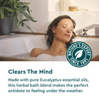 Kneipp herbal bath oil bottle next to cap measuring product volume