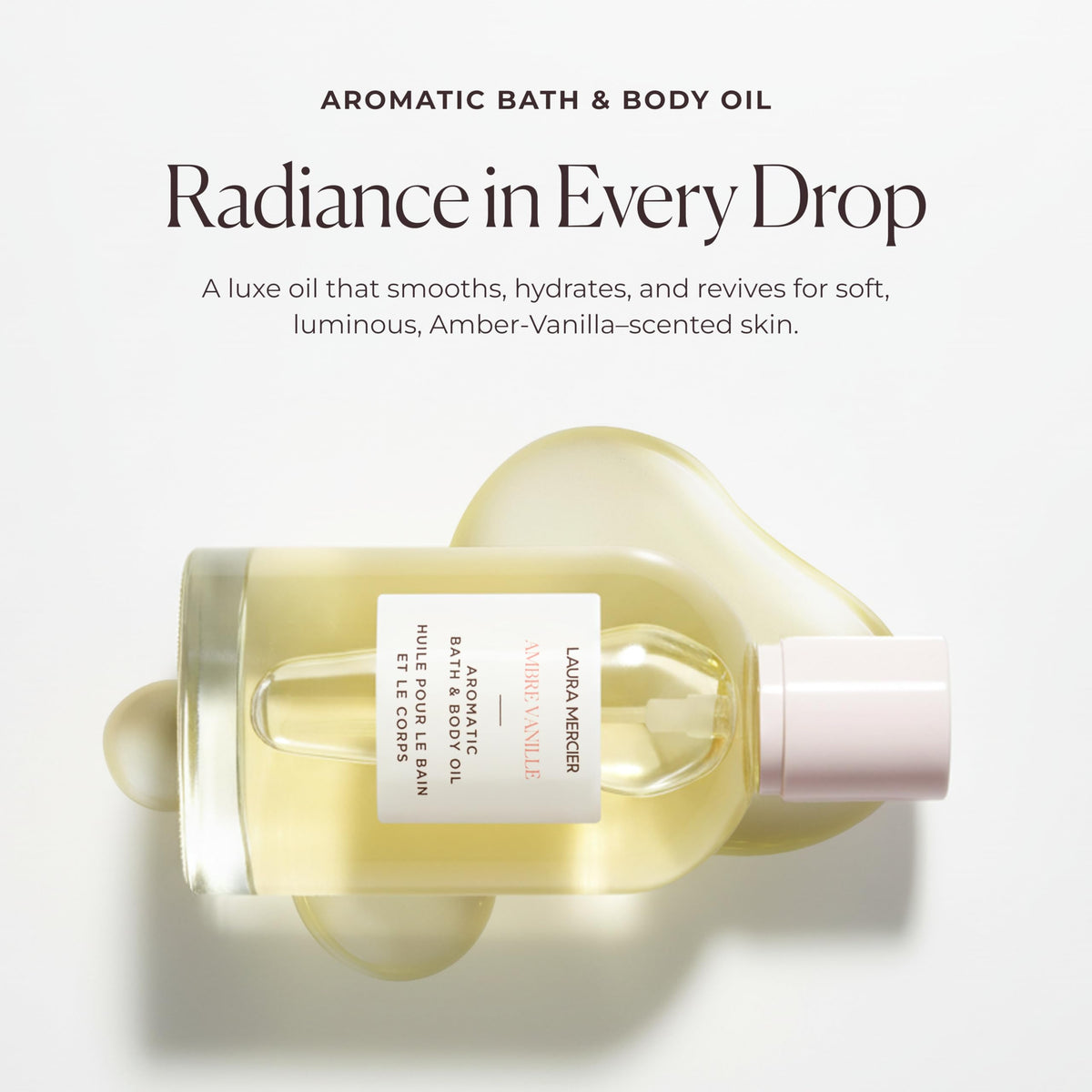 Laura Mercier Ambre Vanille Body Oil bottle next to its retail packaging box