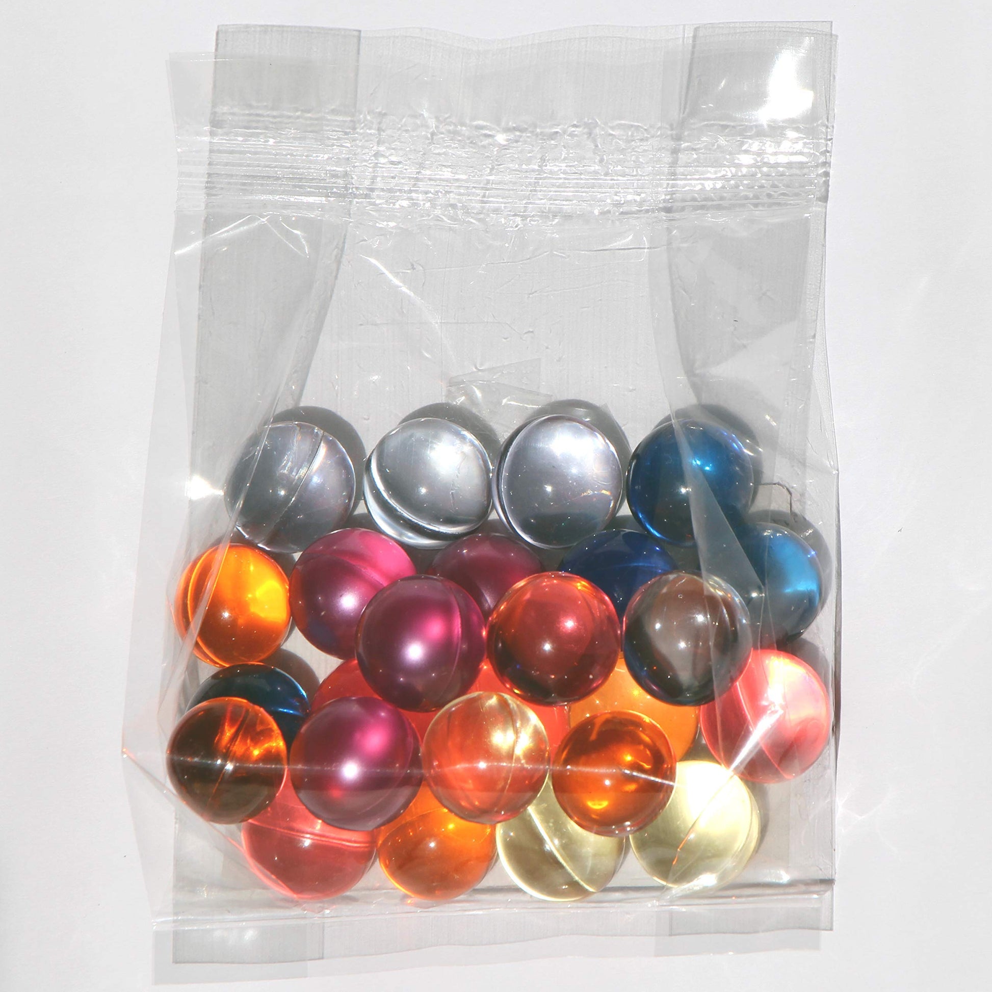 Close up view of the hand sorted assorted color bath oil pearls from SKLEERskincare.