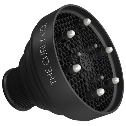 The Curly Co. Travel Diffuser collapsed flat demonstrating its compact storage capabilities.