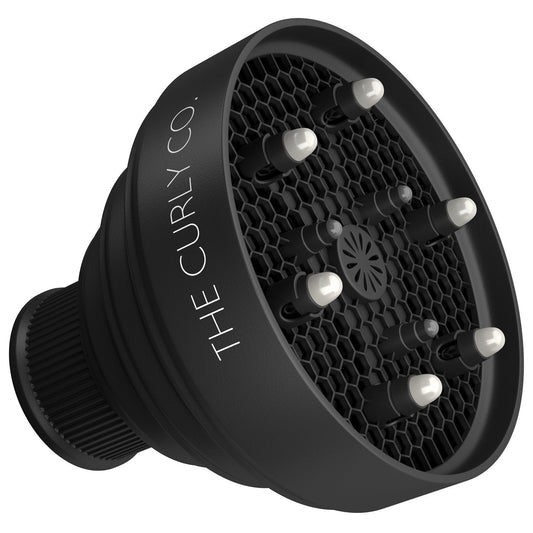 The Curly Co. Travel Diffuser collapsed flat demonstrating its compact storage capabilities.