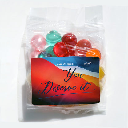 SKLEERskincare luxury floral fragrance bath beads scattered on a clean white surface.
