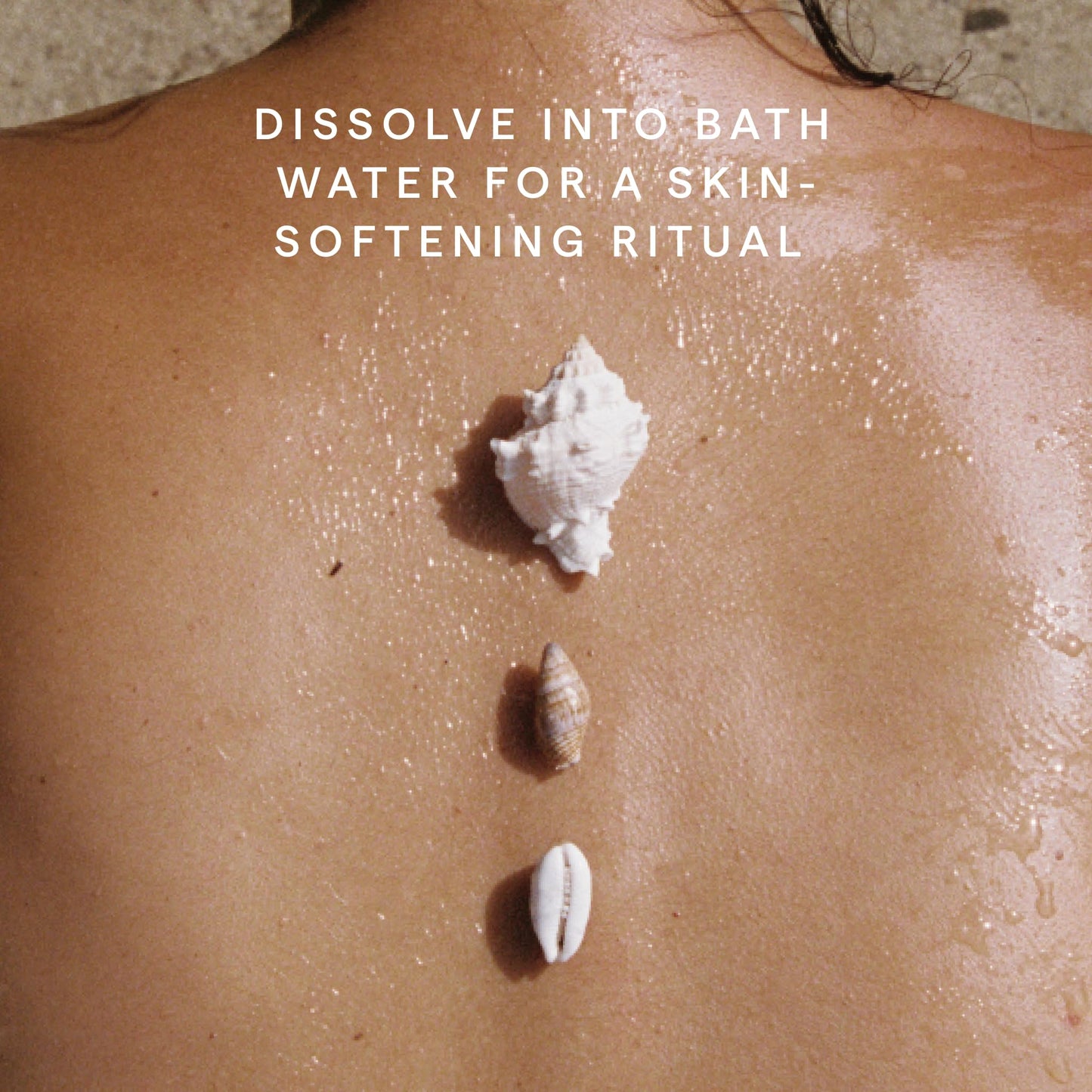 Spa setting with Herbivore Coconut Milk Bath Soak and towels