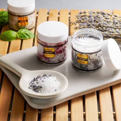 Detailed view of the eucalyptus spearmint and lemon basil aromatherapy salt textures inside the clear jars.