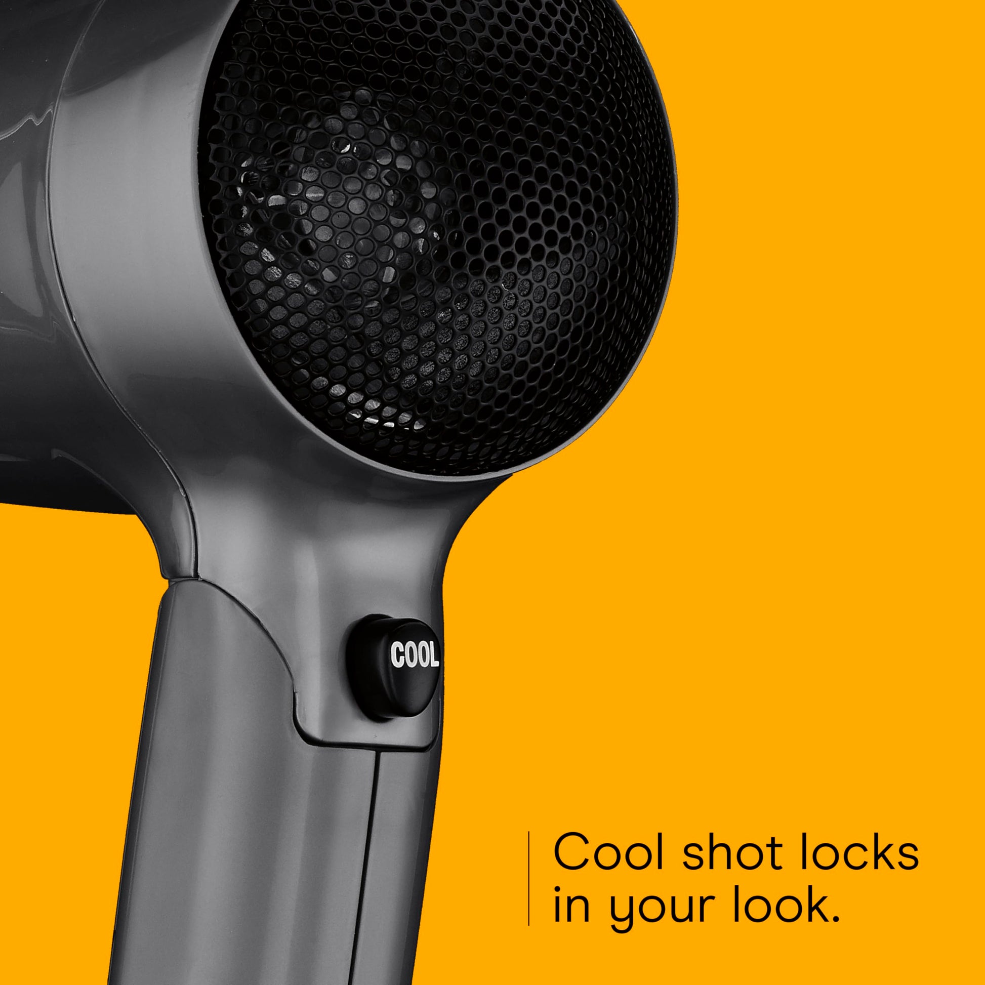 Conair dual voltage dryer showing the cool shot button position below the barrel