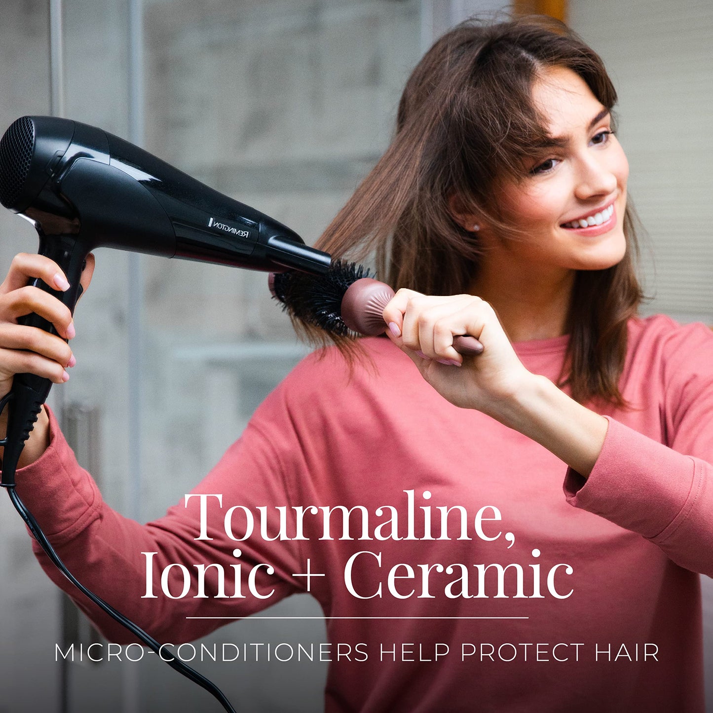 Side profile of the black Remington damage control hair dryer highlighting the protective rear air grille.