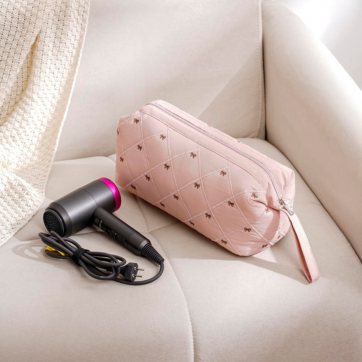 Hair styling tools stored inside the beige storage case