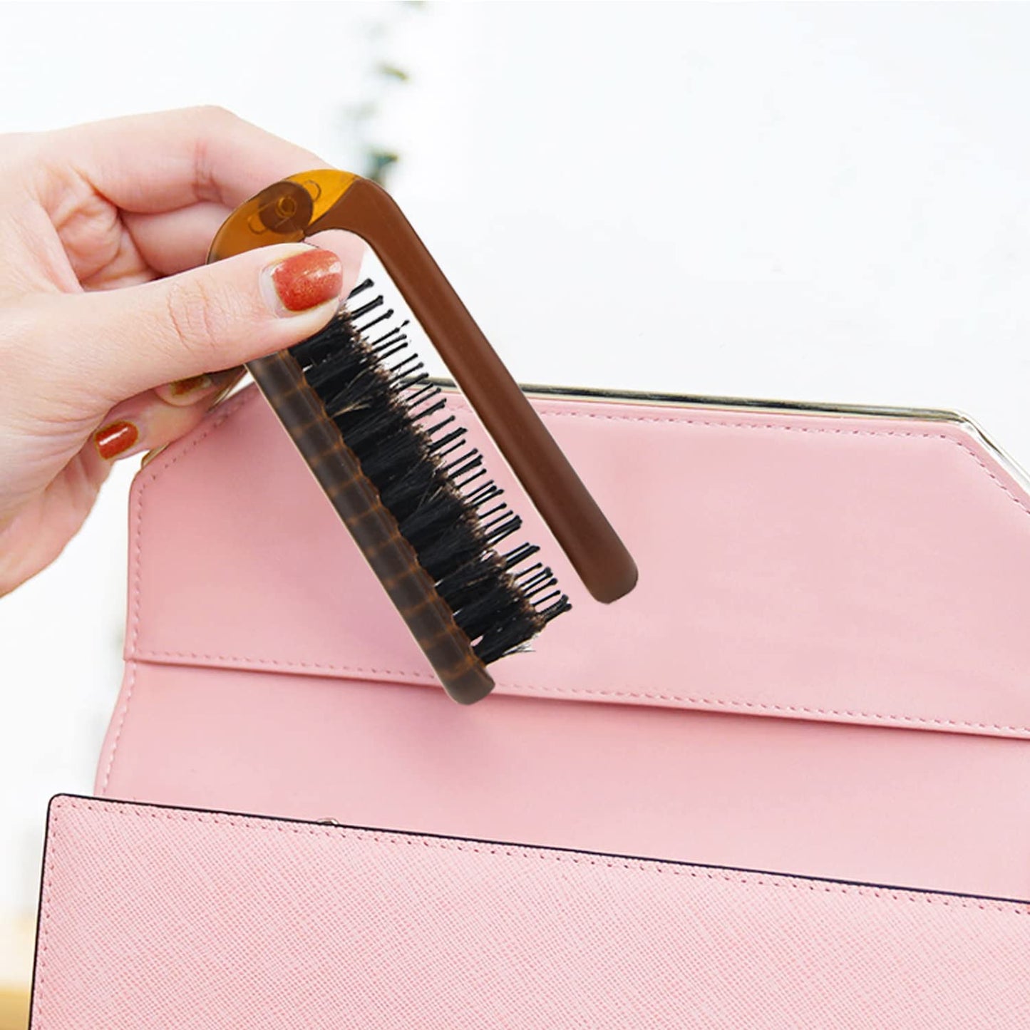 Ancable travel hair brush showing 180 degree folding mechanism