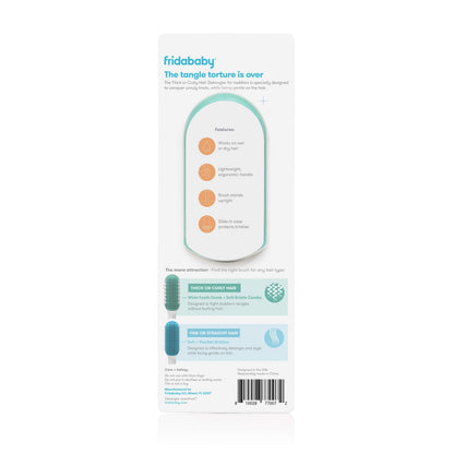 Frida Baby detangler brush held in hand showing ergonomic handle