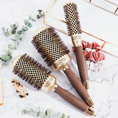 Olivia Garden round thermal hair brush being held to demonstrate the lightweight ergonomic grip