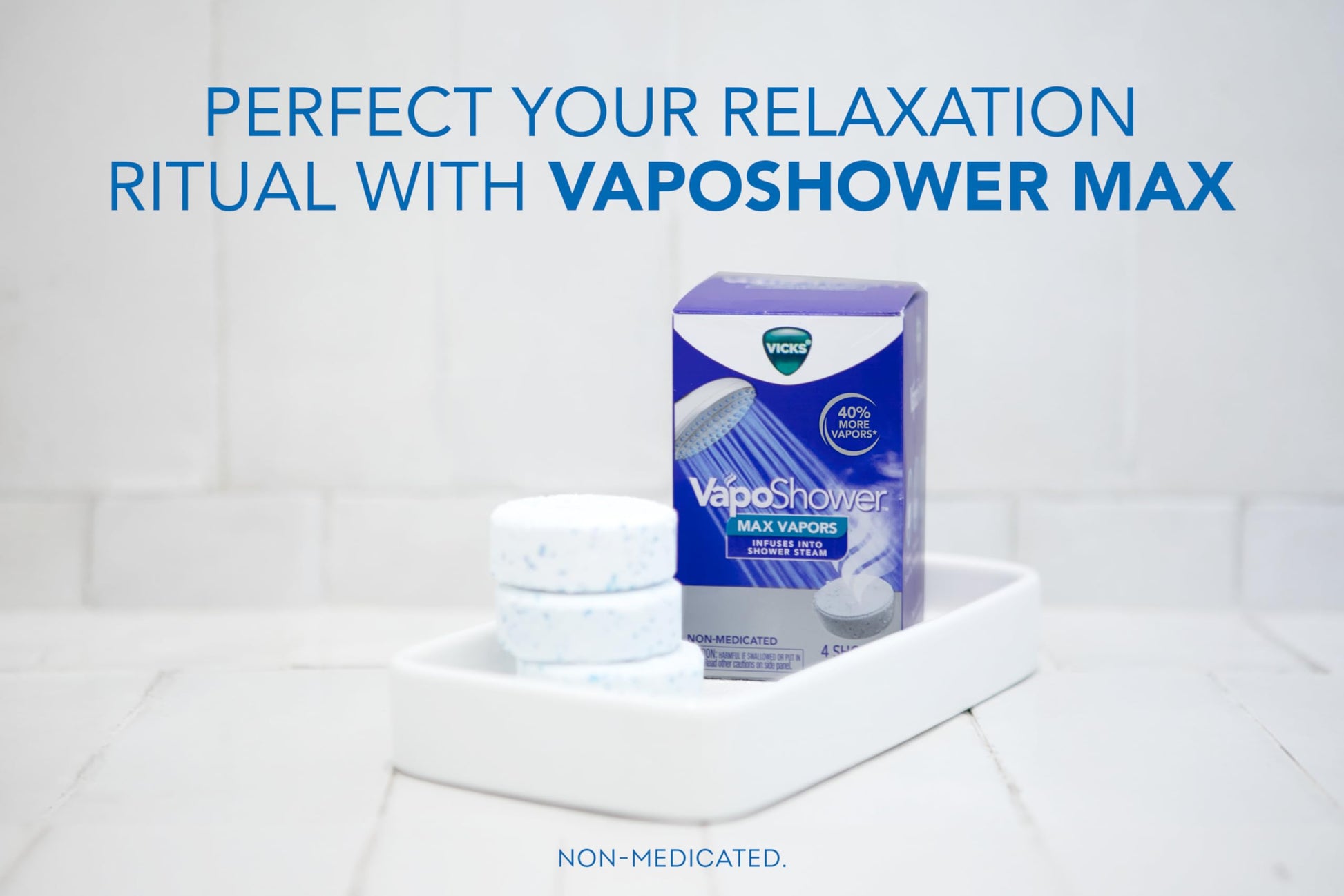 Vicks aromatherapy shower tablets dissolving under warm running water on bathroom tiles