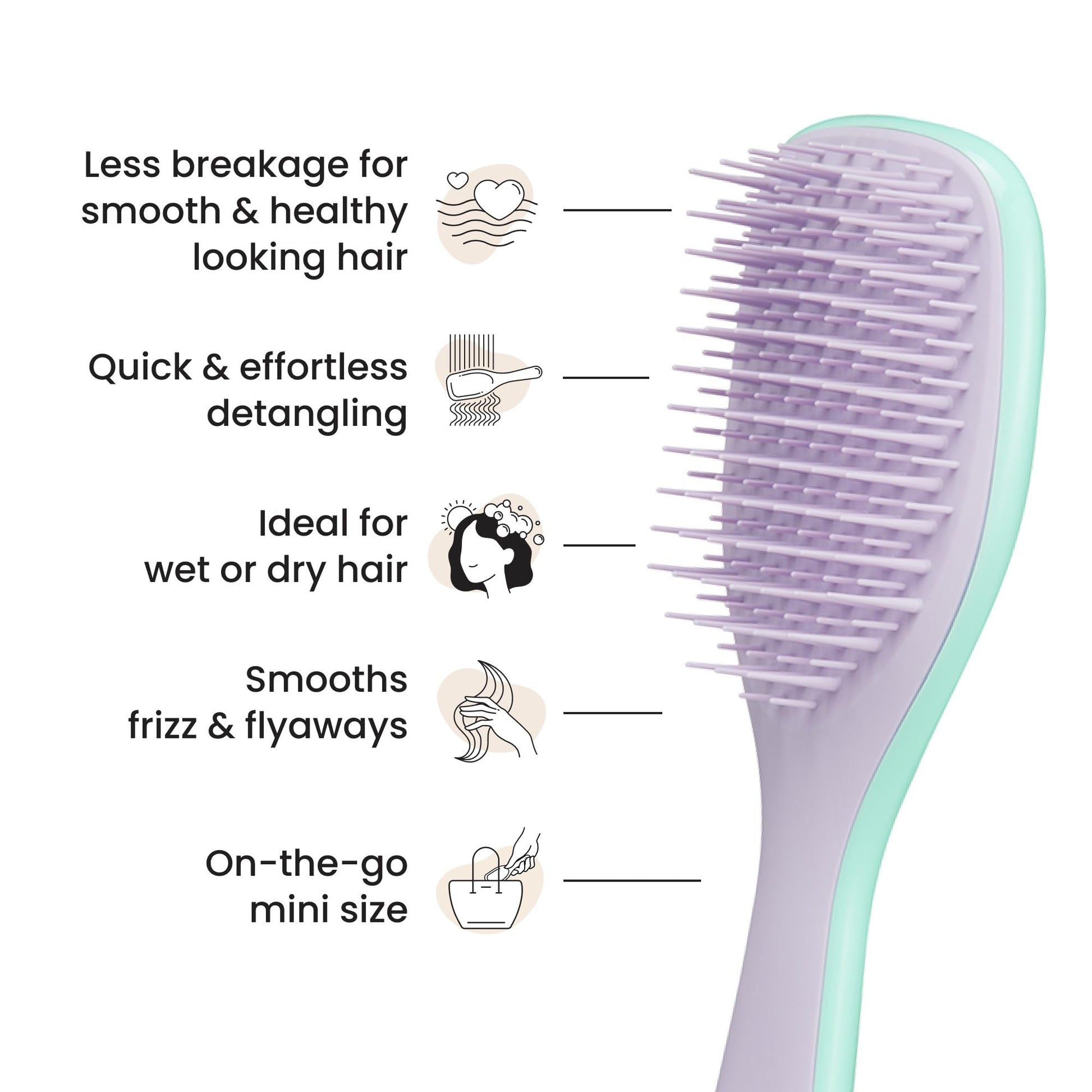 Hand holding Tangle Teezer Mini brush for size reference