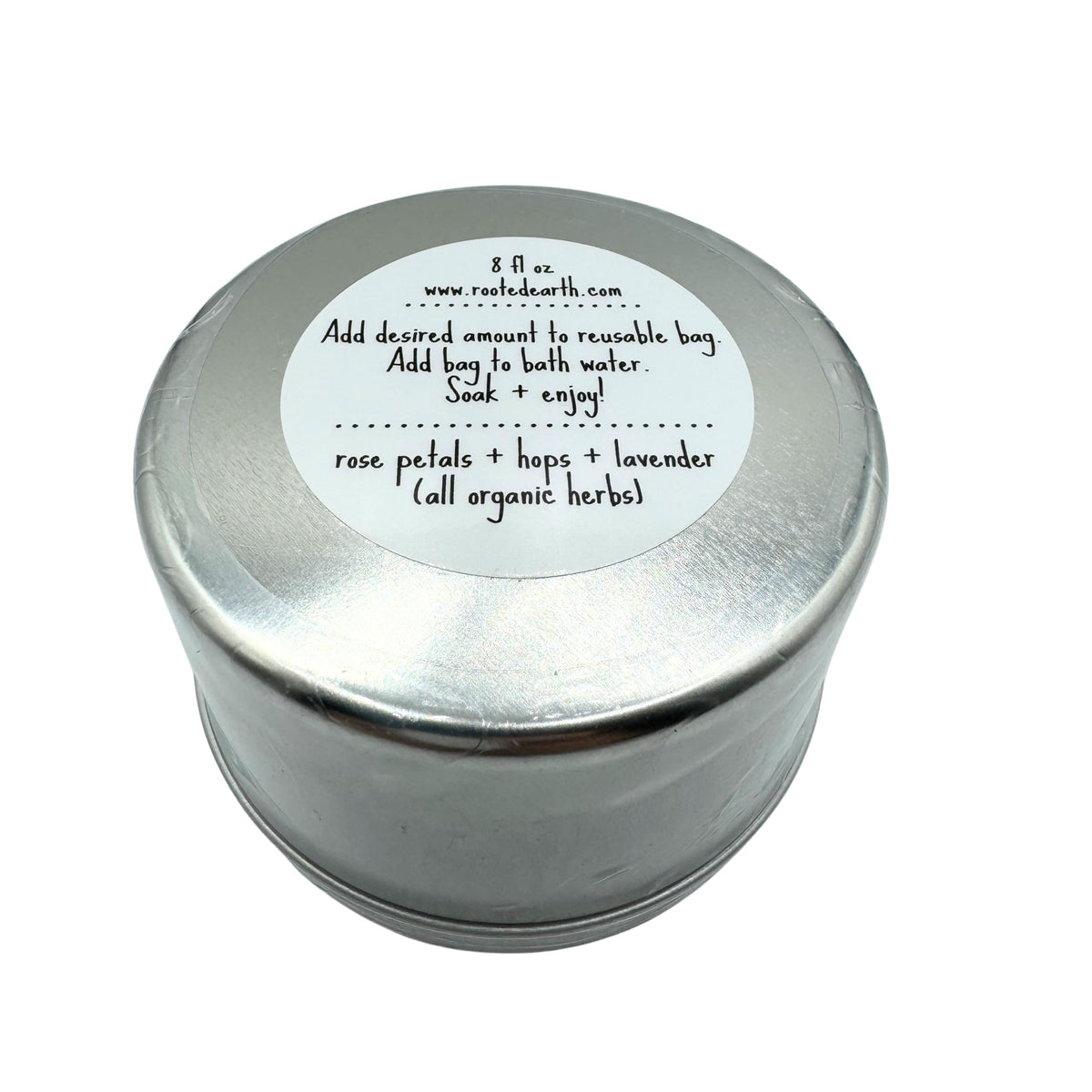Rooted Earth relaxation herbal bath tea tin next to a filled muslin bag
