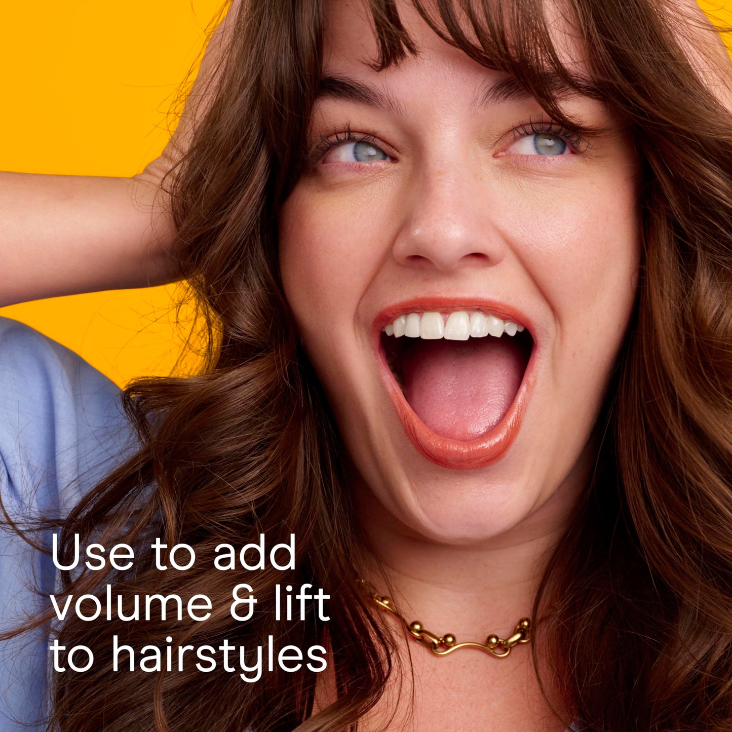 Conair salon performance brush being held to illustrate the secure ridged handle grip and comfortable sizing.
