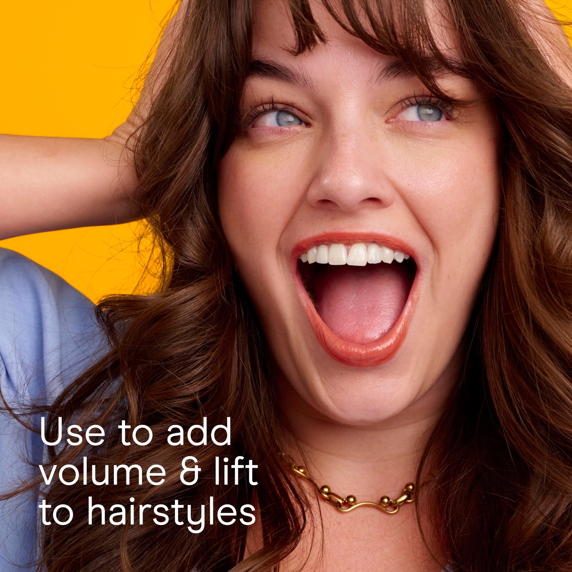 Conair salon performance brush being held to illustrate the secure ridged handle grip and comfortable sizing.