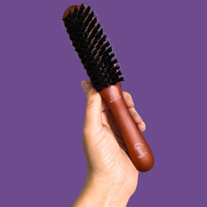 Goody full grooming boar hair brush showing the ergonomic long brown wood handle design