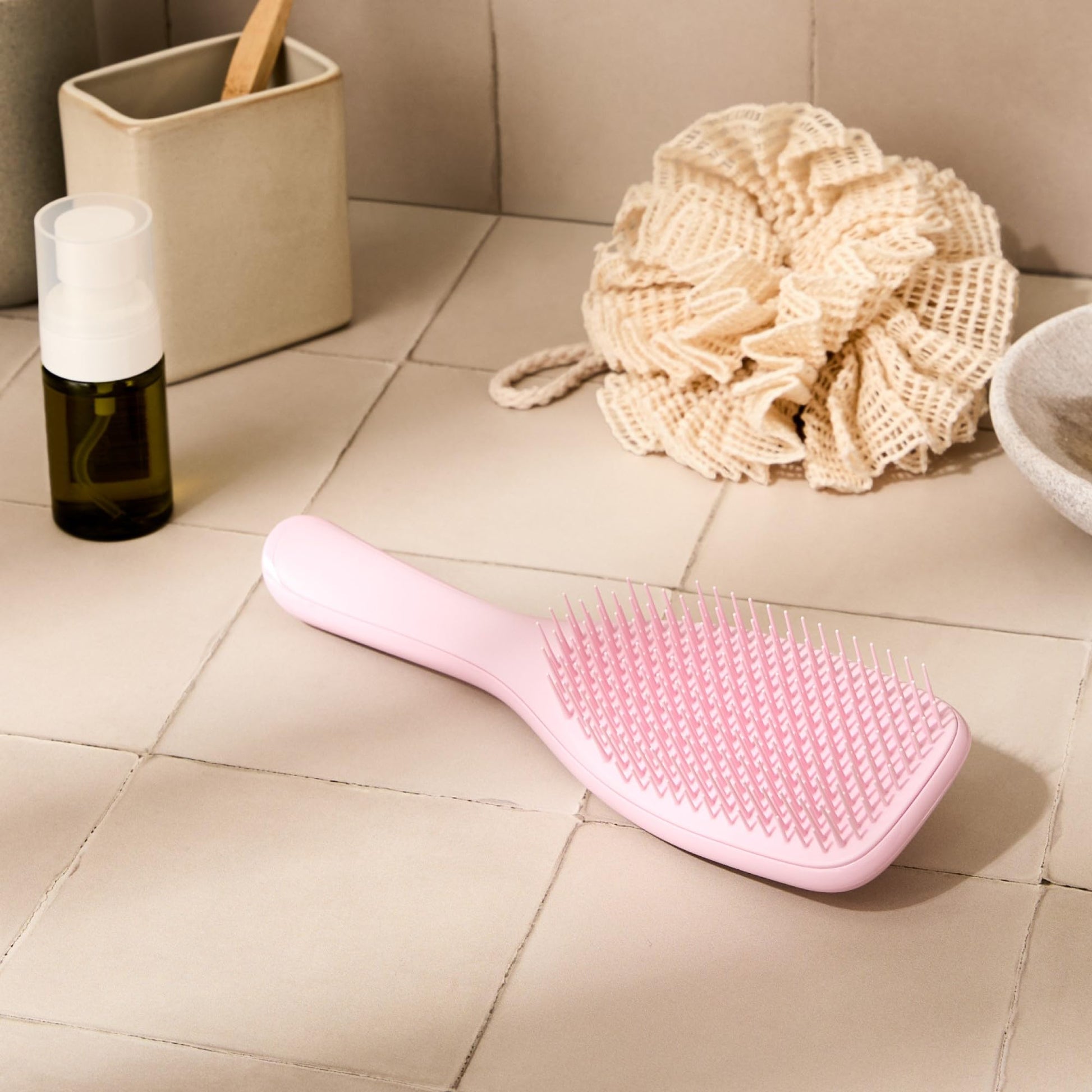 Tangle Teezer detangling brush held in hand for size reference