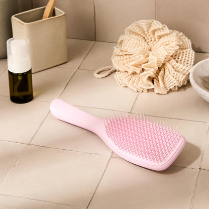 Tangle Teezer detangling brush held in hand for size reference