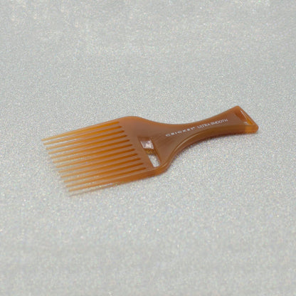 Cricket Ultra Smooth Hair Pick Comb showcasing its amber color and professional styling quality.