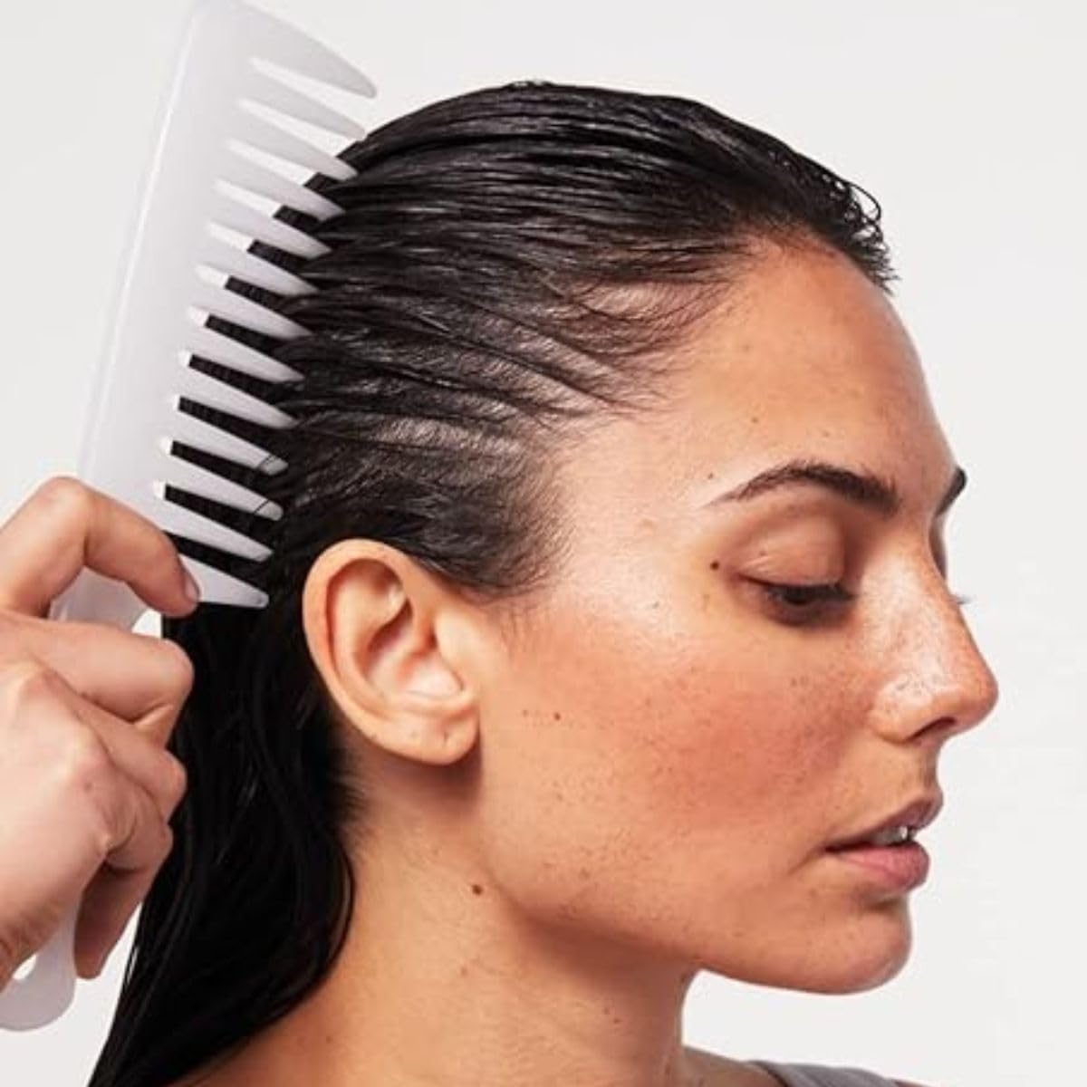 Paul Mitchell white styling tool showcasing the ergonomic handle for wet hair grooming.