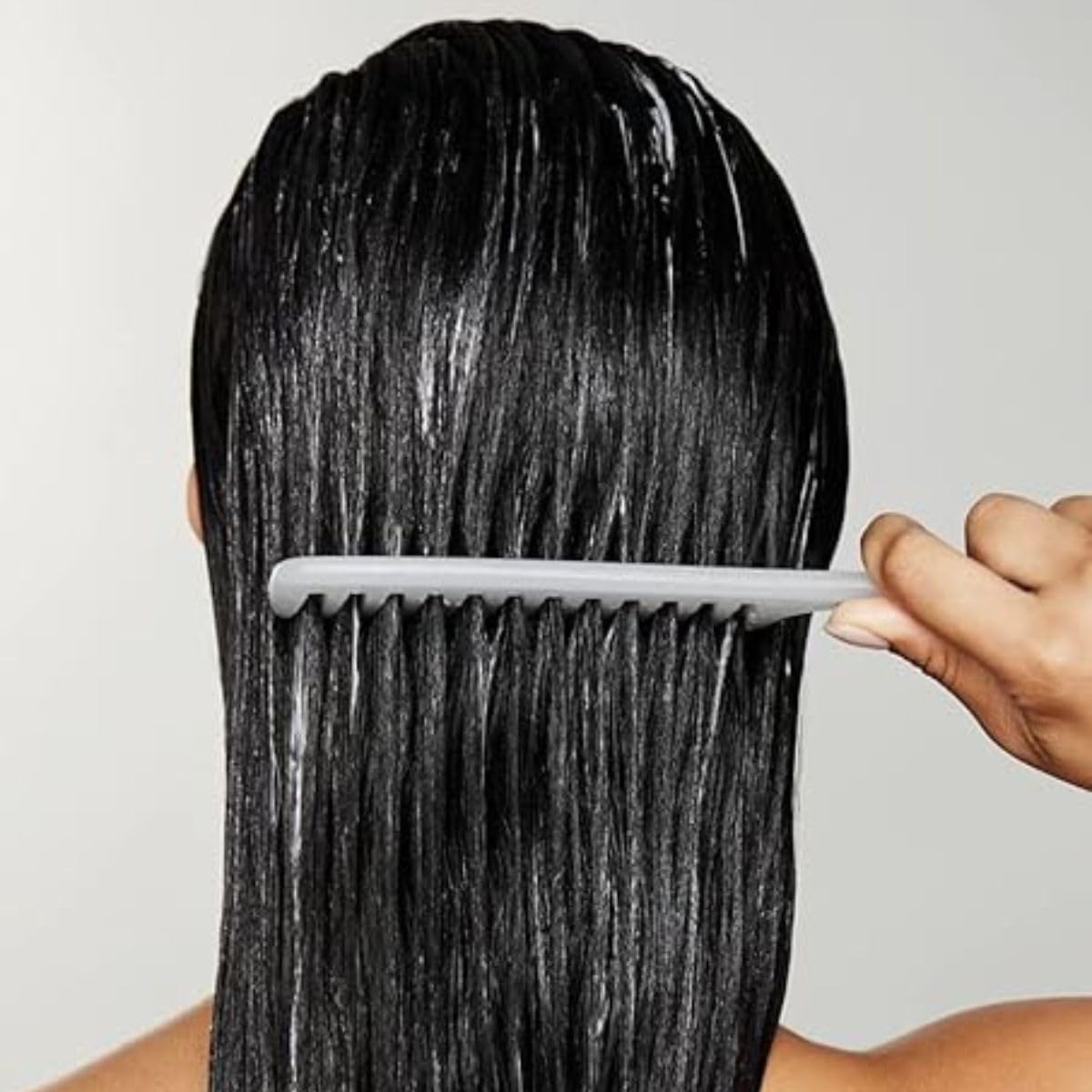 Paul Mitchell Pro Tools wide spacing tooth comb highlighting the antibacterial protection feature.