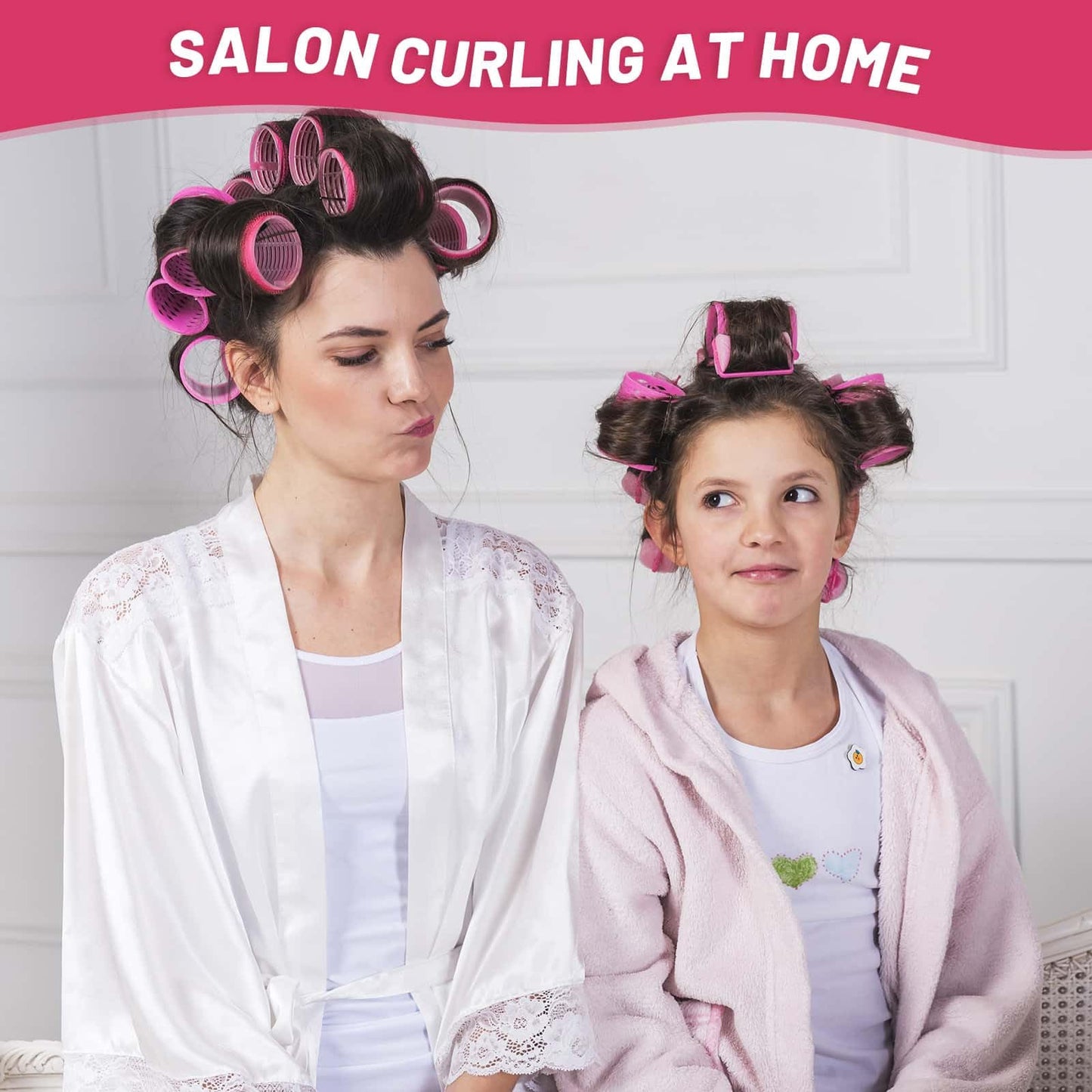 Twelve pieces of large pink velcro curlers arranged next to premium duckbill clips