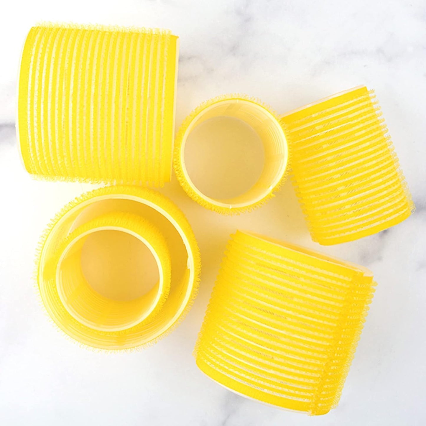 Close up view of the yellow self grip material on the Drybar hair rollers.