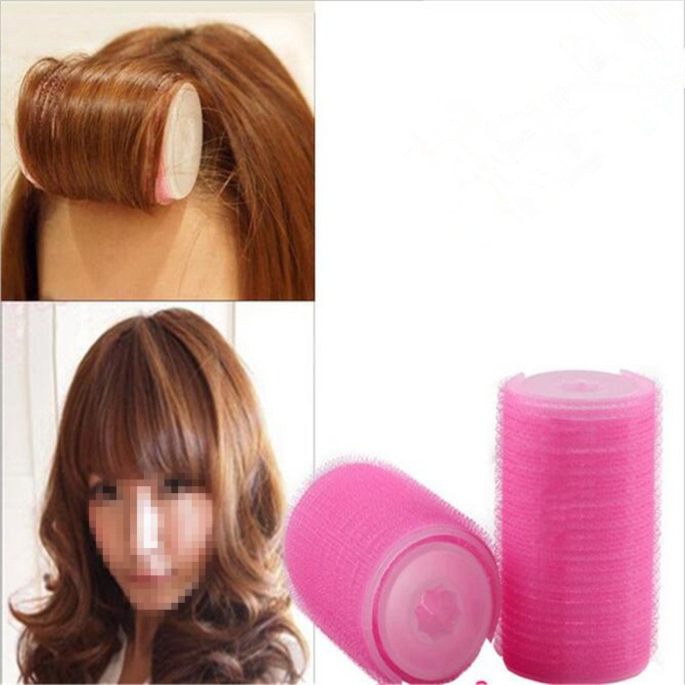 Pink self grip hair rollers showing the textured self-adhesive surface close up.