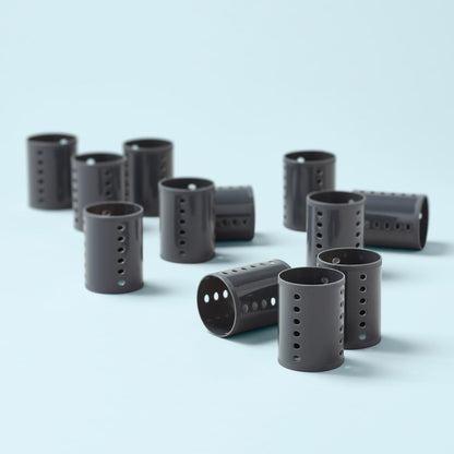Vented grey hair curlers showing strategic airflow holes for fast drying.
