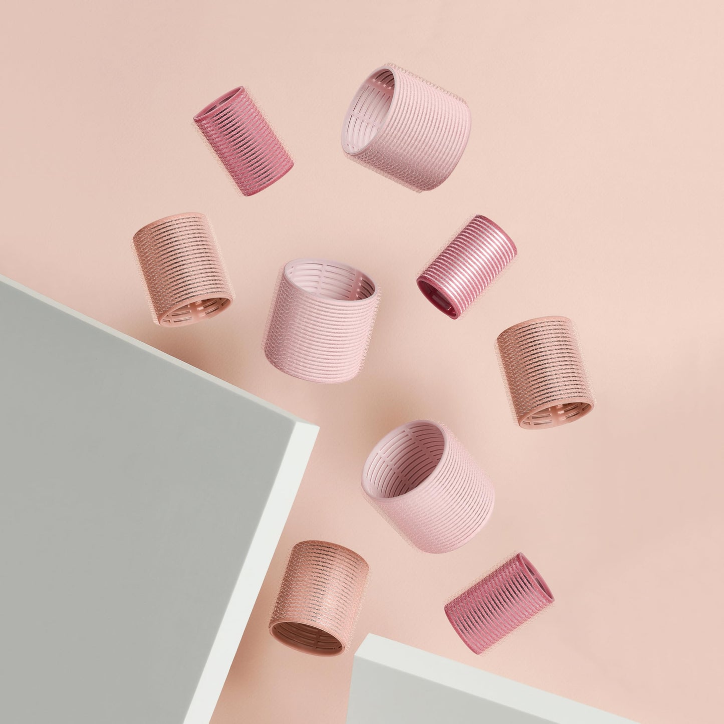 The complete nine piece hair roller kit displaying the variance in sizing for custom styles