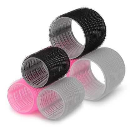 Pink hair rollers with duckbill clips and sectioning rat tail comb for heat free styling
