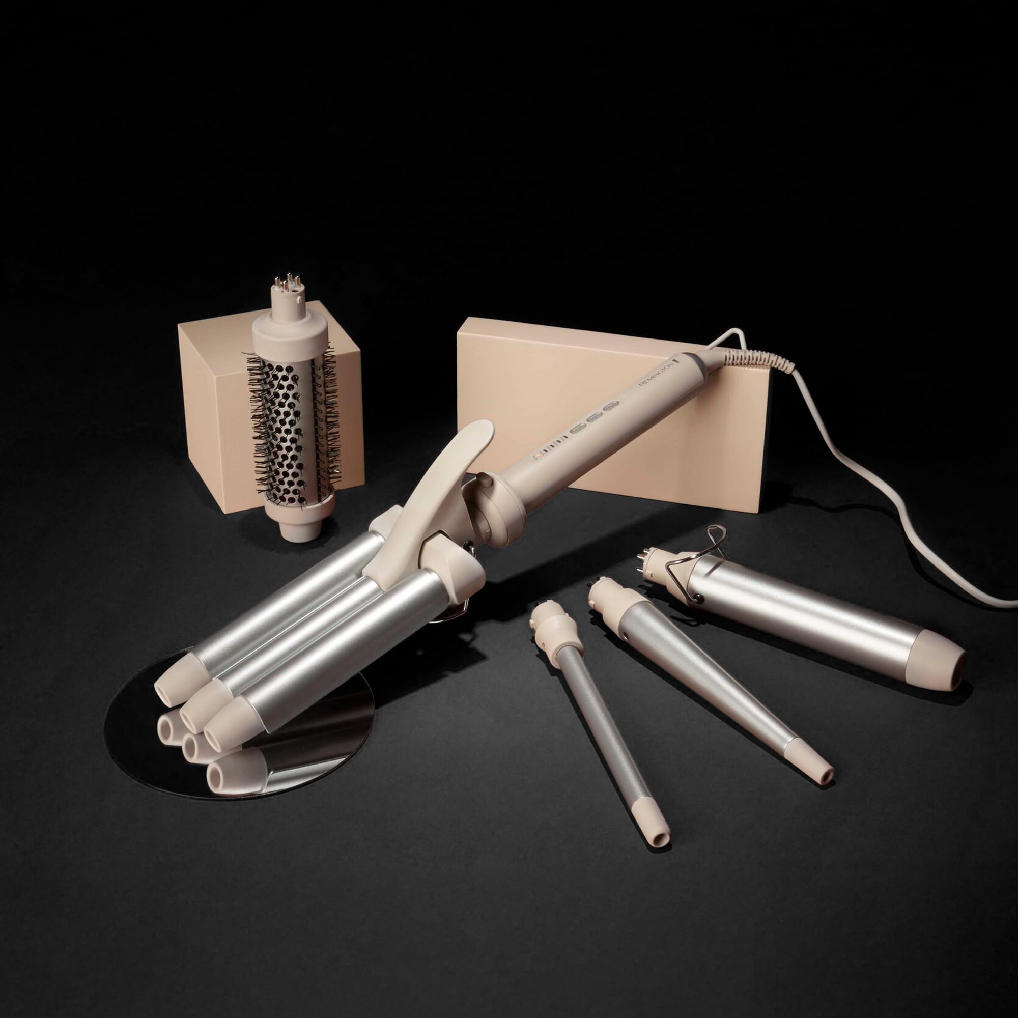 Remington interchangeable curling iron kit showcasing the four distinct ceramic barrels and the volumizing hot air round brush.