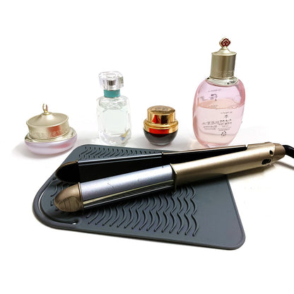 Lessmon heat resistant pad shown with a flat iron resting safely on a vanity countertop