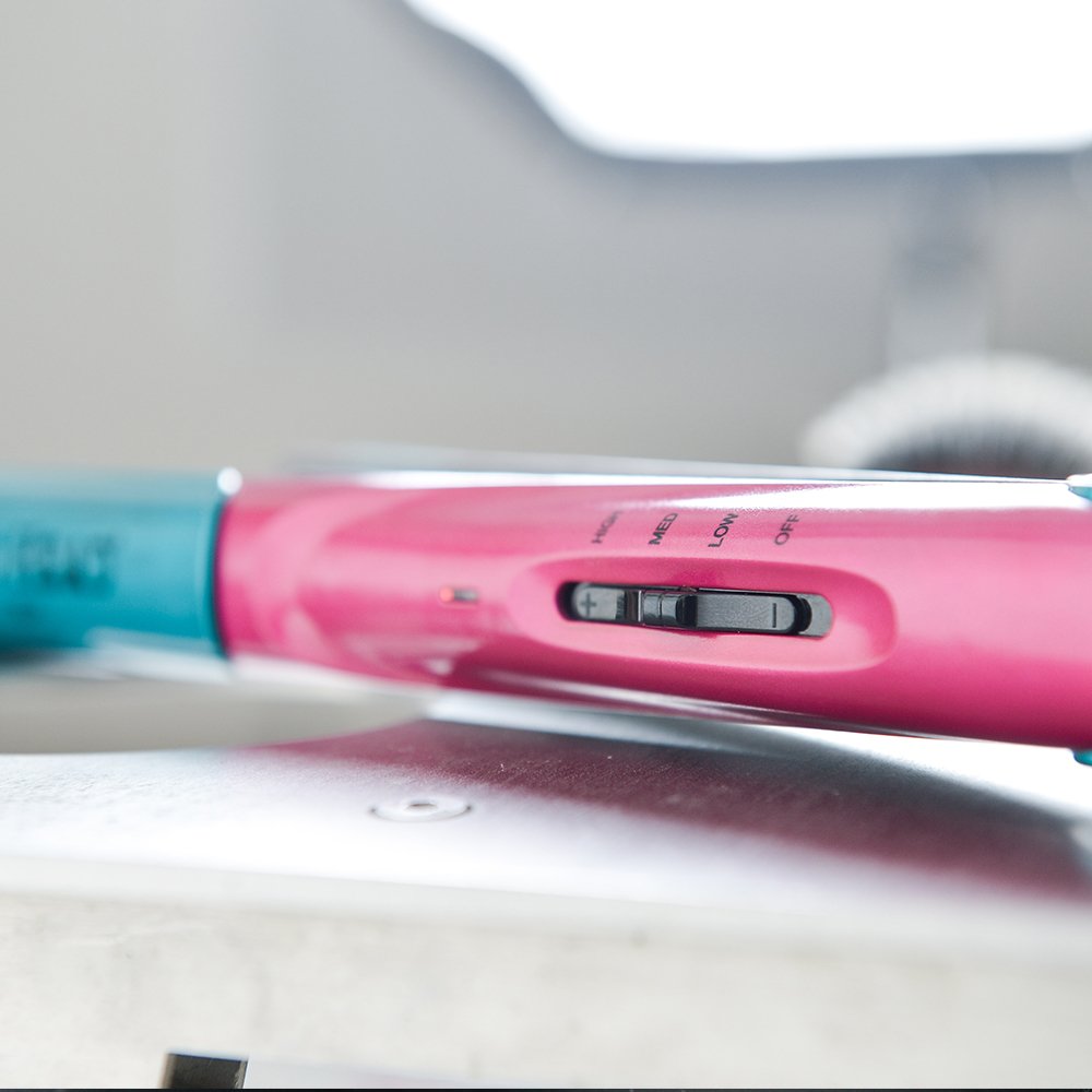 Side profile of the Bed Head volume styling iron highlighting the temperature control wheel
