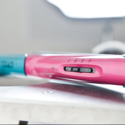 Side profile of the Bed Head volume styling iron highlighting the temperature control wheel