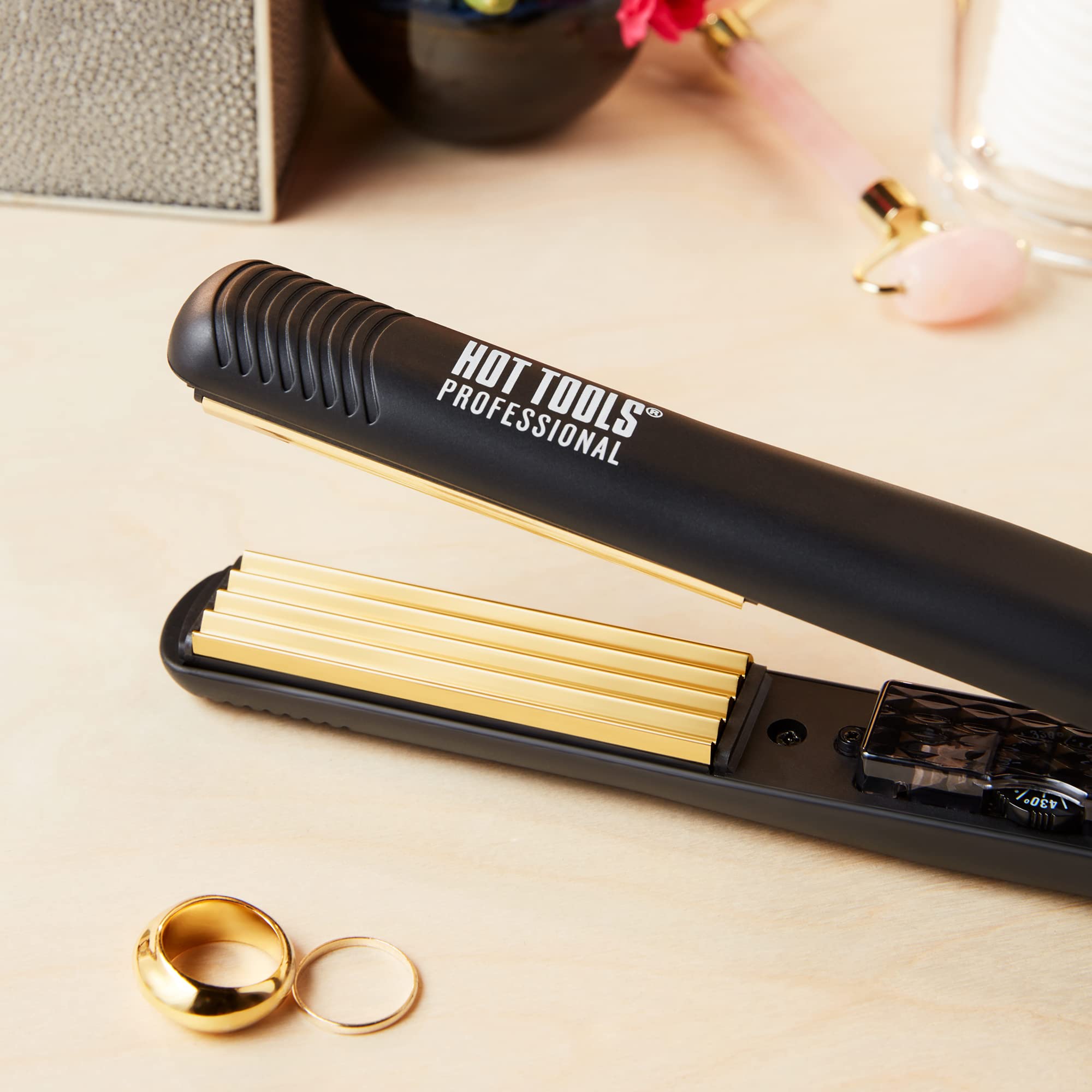 Hot Tools gold styling iron showing the sleek profile and professional swivel cord