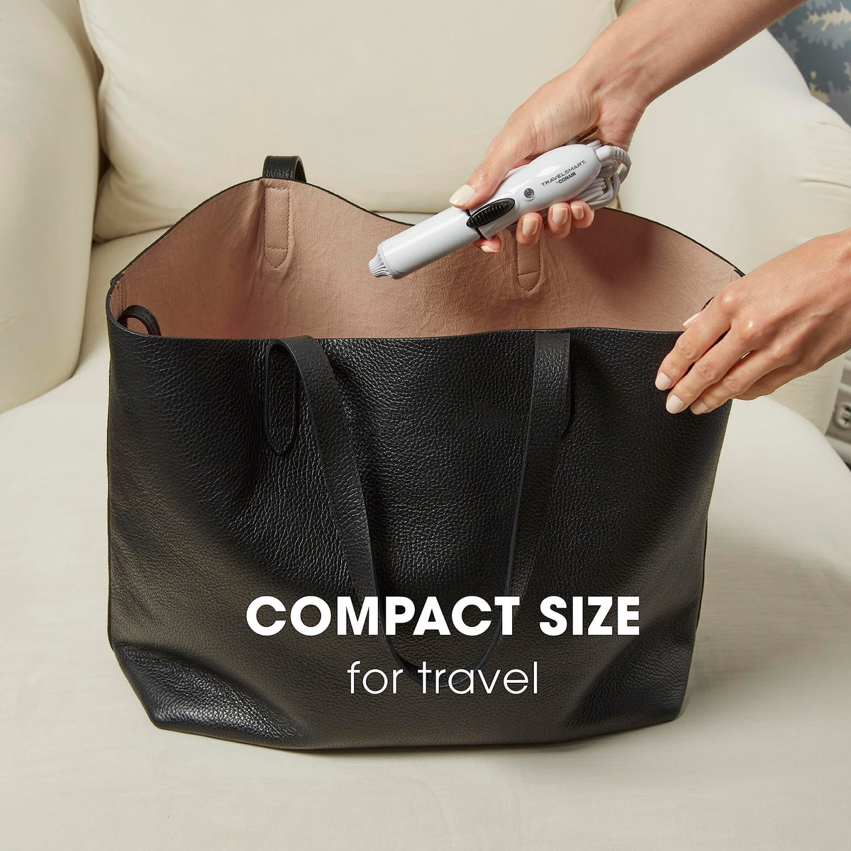Compact Conair Travel Smart hair curler held in hand showing portable small size