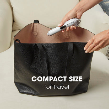 Compact Conair Travel Smart hair curler held in hand showing portable small size