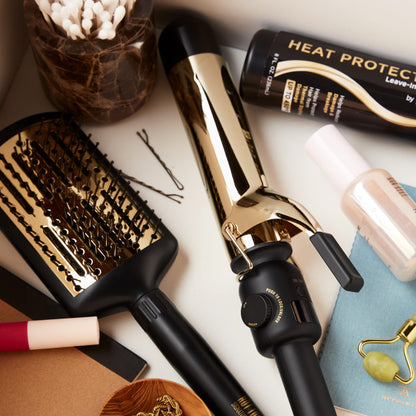 Hot Tools digital gold curling iron displaying the safety stand and temperature control buttons